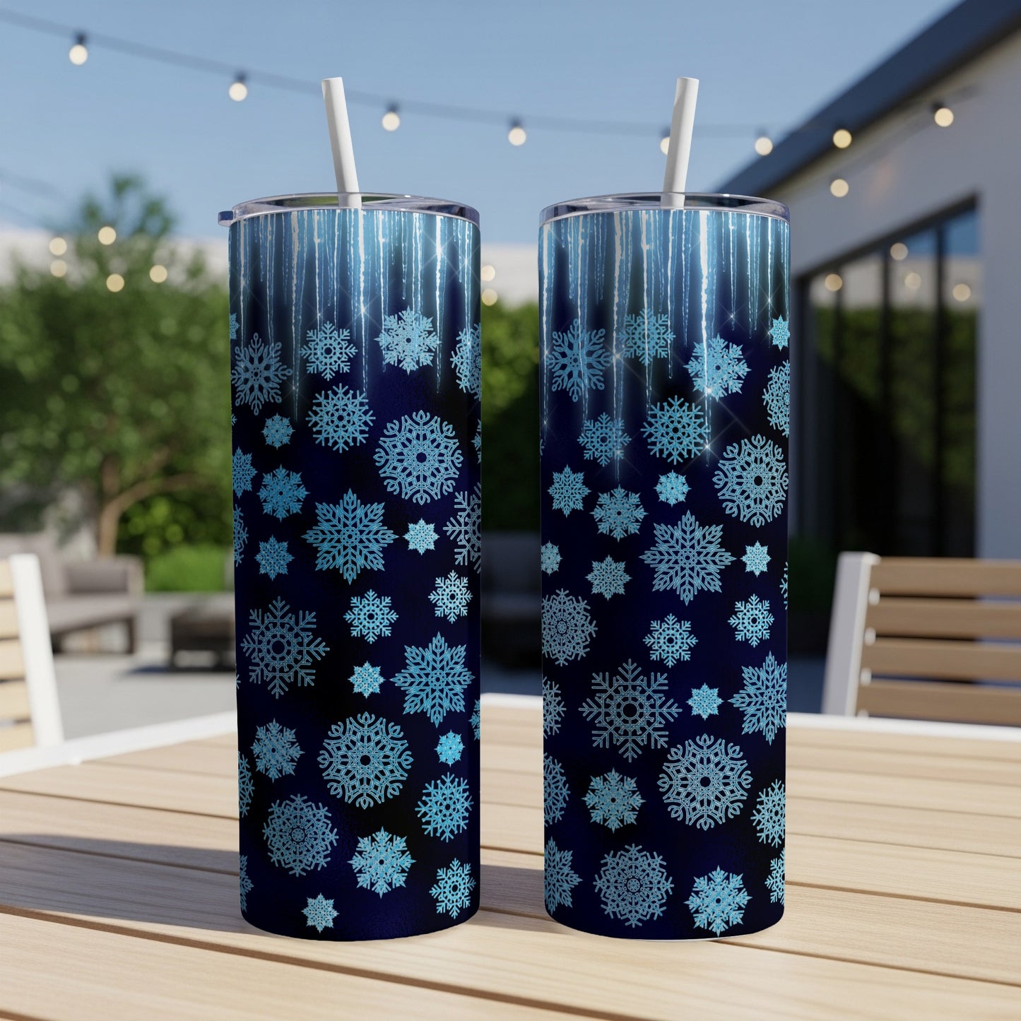 Two tall tumblers with a blue snowflake and glitter design.