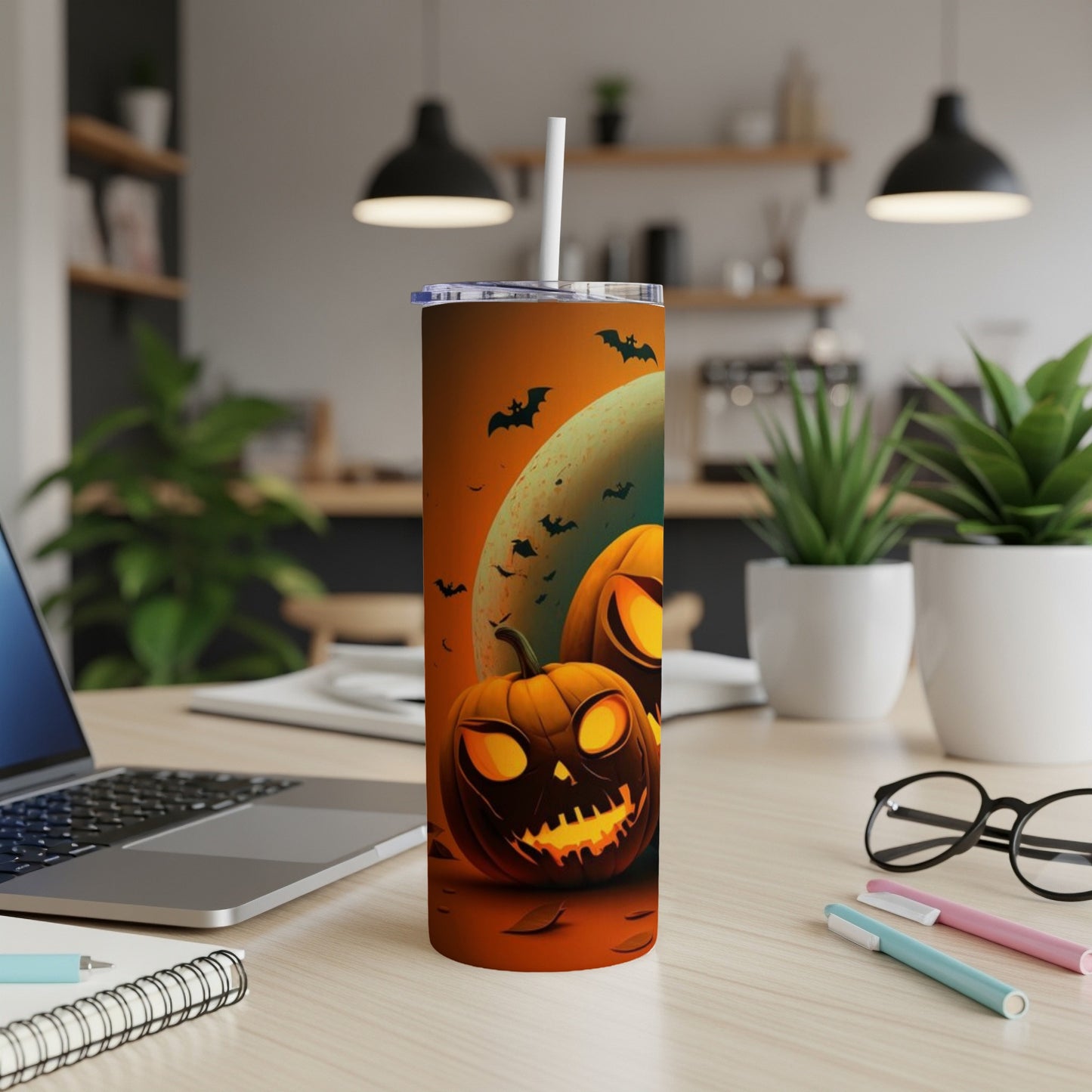 Tumbler with jack-o'-lanterns, bats, and moon on an orange background.