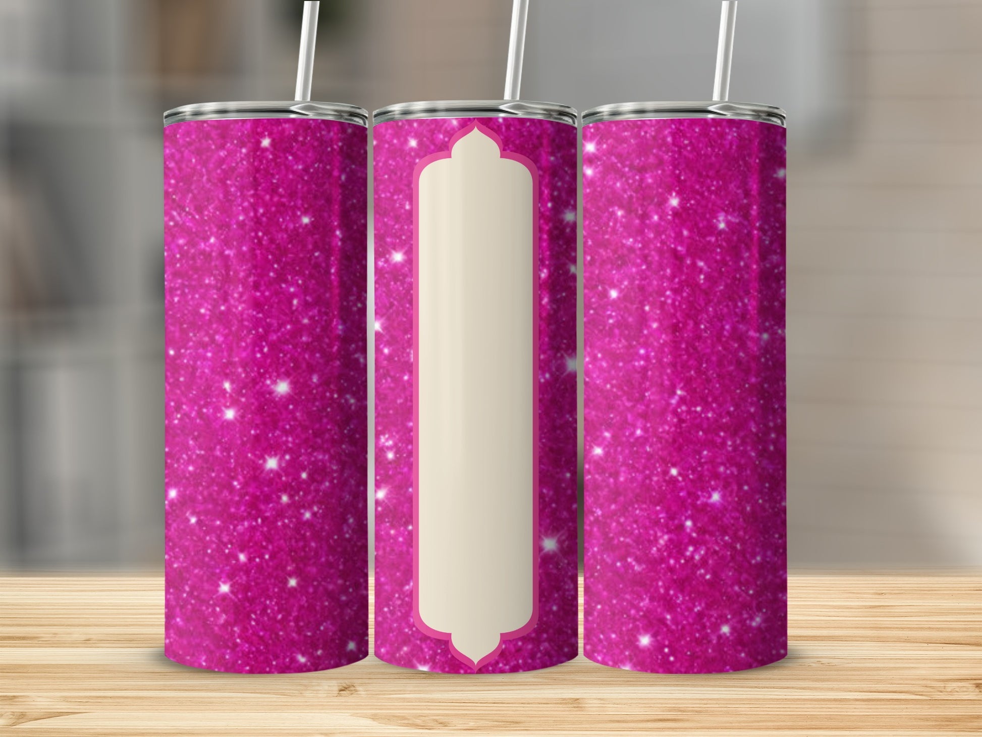 Pink glitter tumbler with cream-colored centerpiece on wooden surface.