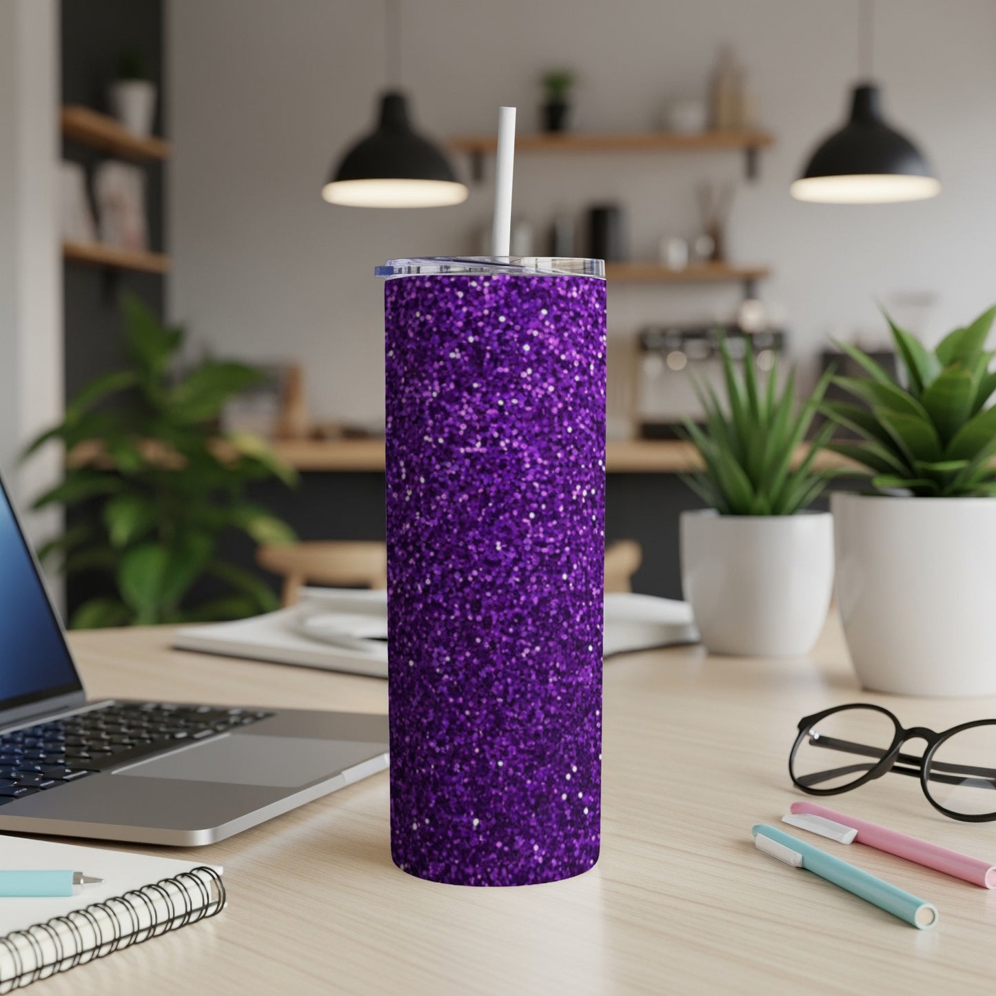 Purple glitter tumbler with white straw on a desk.