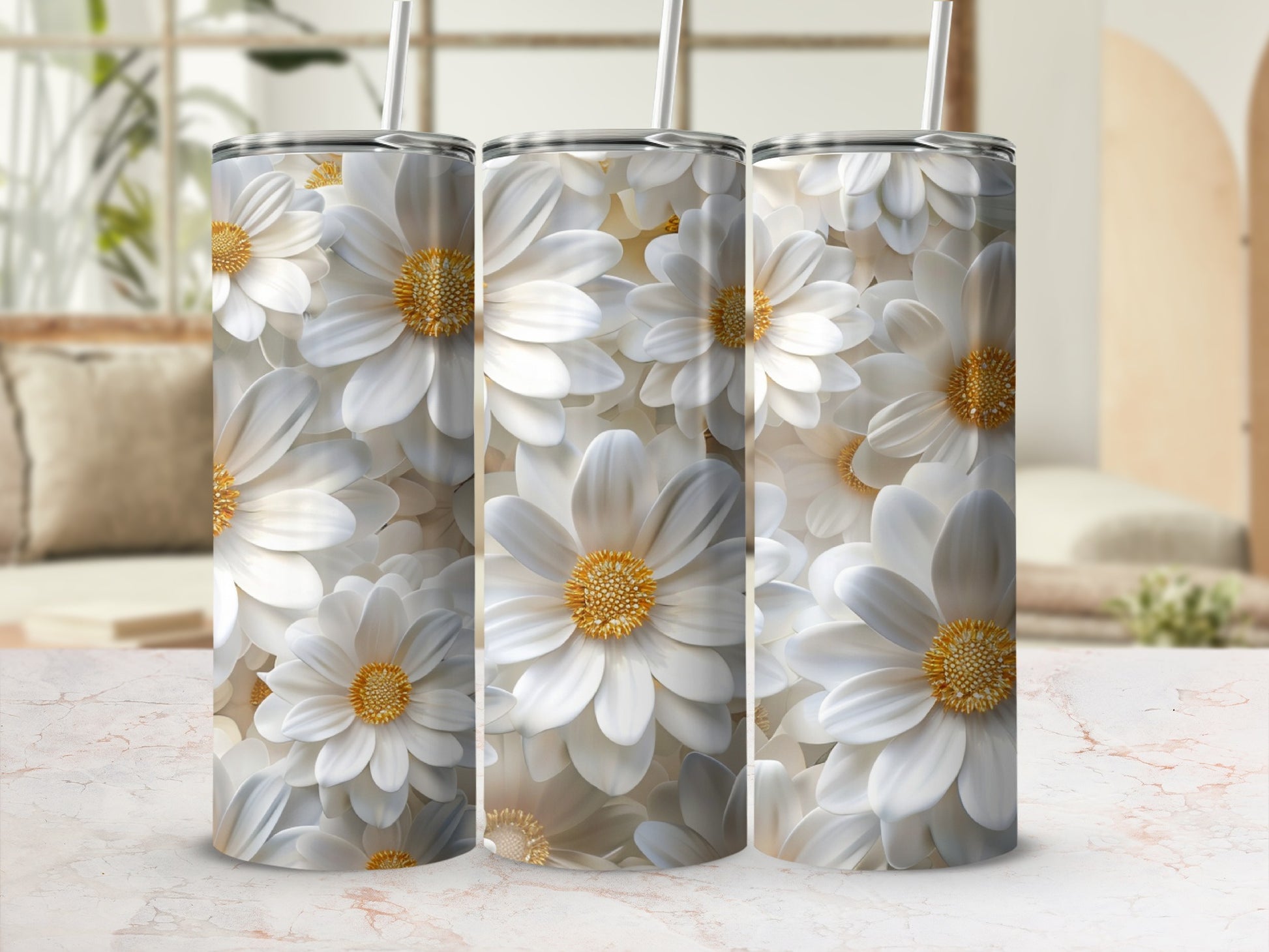 Three tumblers with white floral patterns displayed on a marble surface.