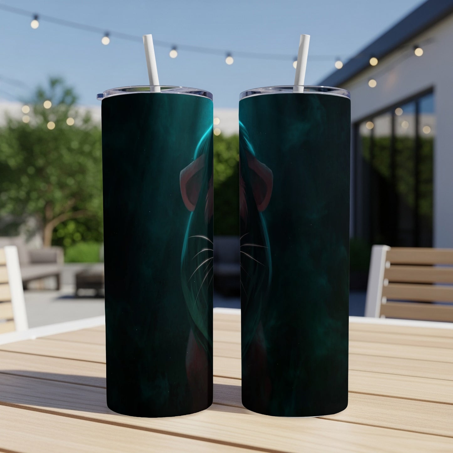 Two tumblers with a glowing green feline mask design on a table.