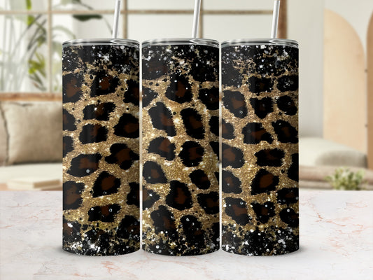 Three glittery leopard print tumblers with straws on a marble surface.