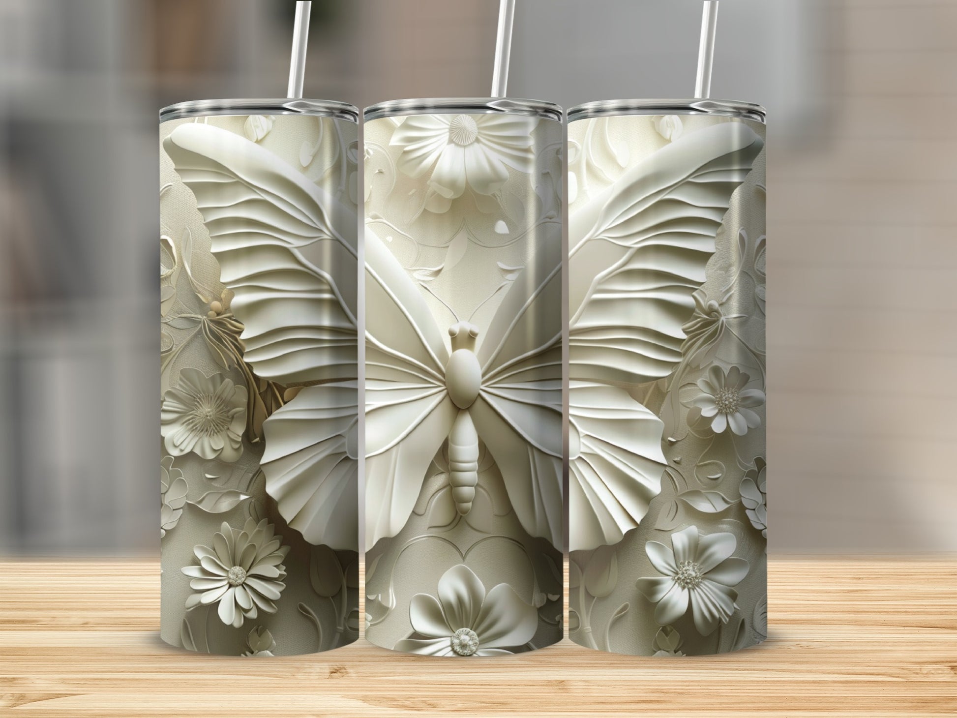 Three white tumblers with embossed butterfly and floral designs.