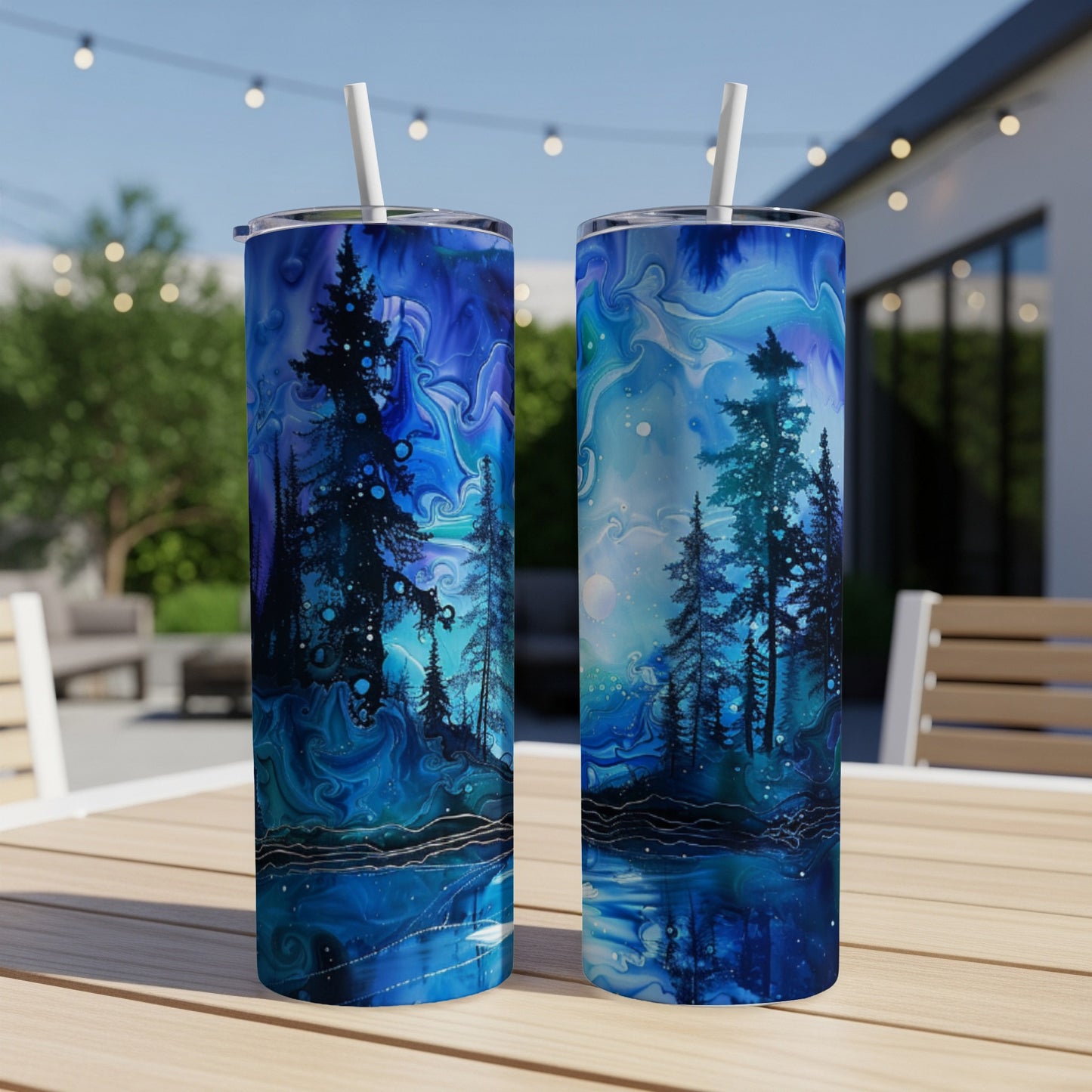 Two tumblers with a starry night forest scene and reflective water.