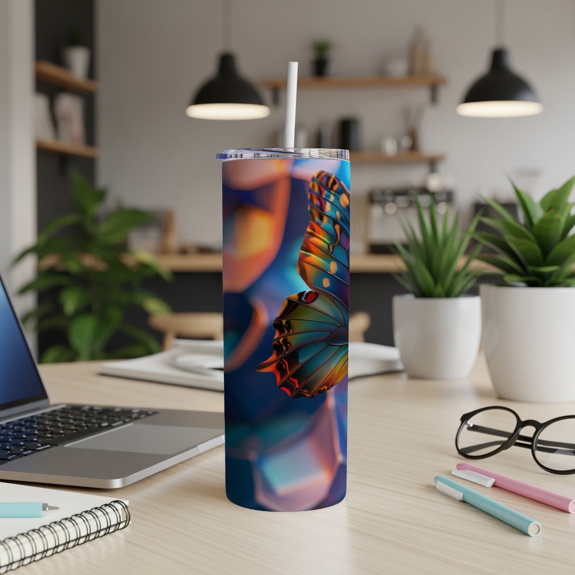 Tall tumbler with colorful butterfly design on a wooden desk.
