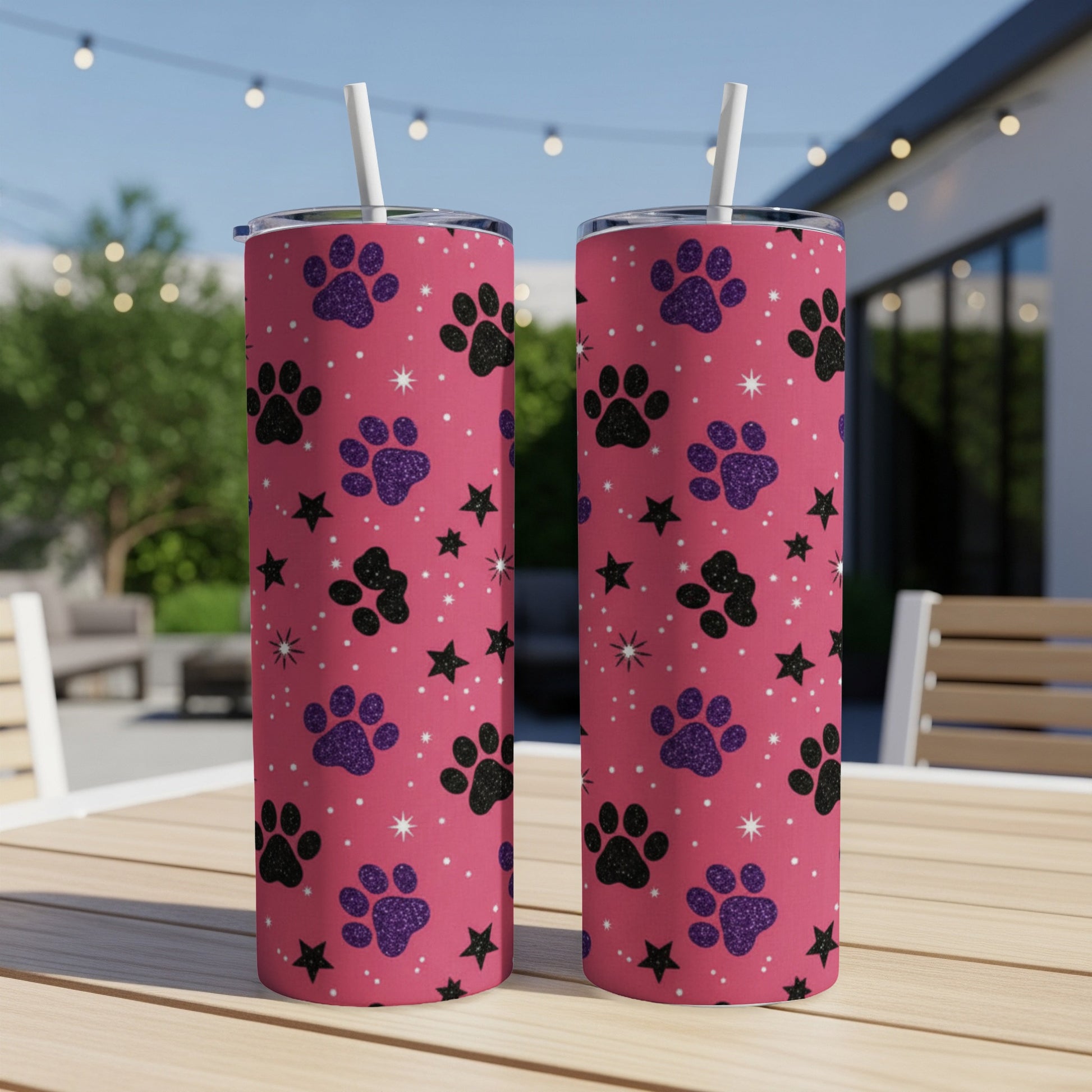 Pink tumbler with paw print and star pattern, includes straw.