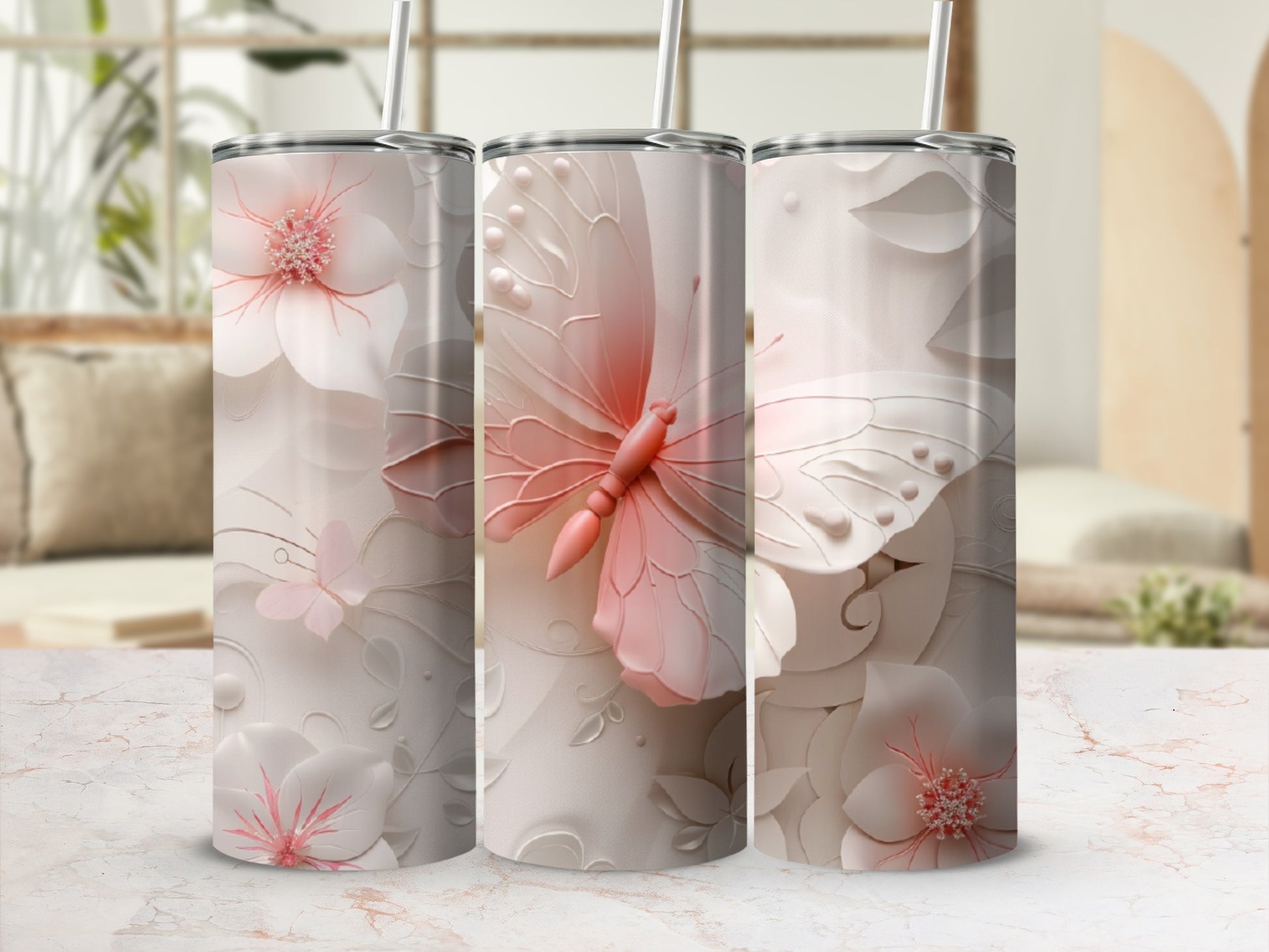 Three tall tumblers with pale pink butterflies and floral designs.
