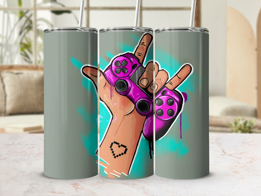 Pink video game controller held by hand with pixel art tattoo and teal spray paint.