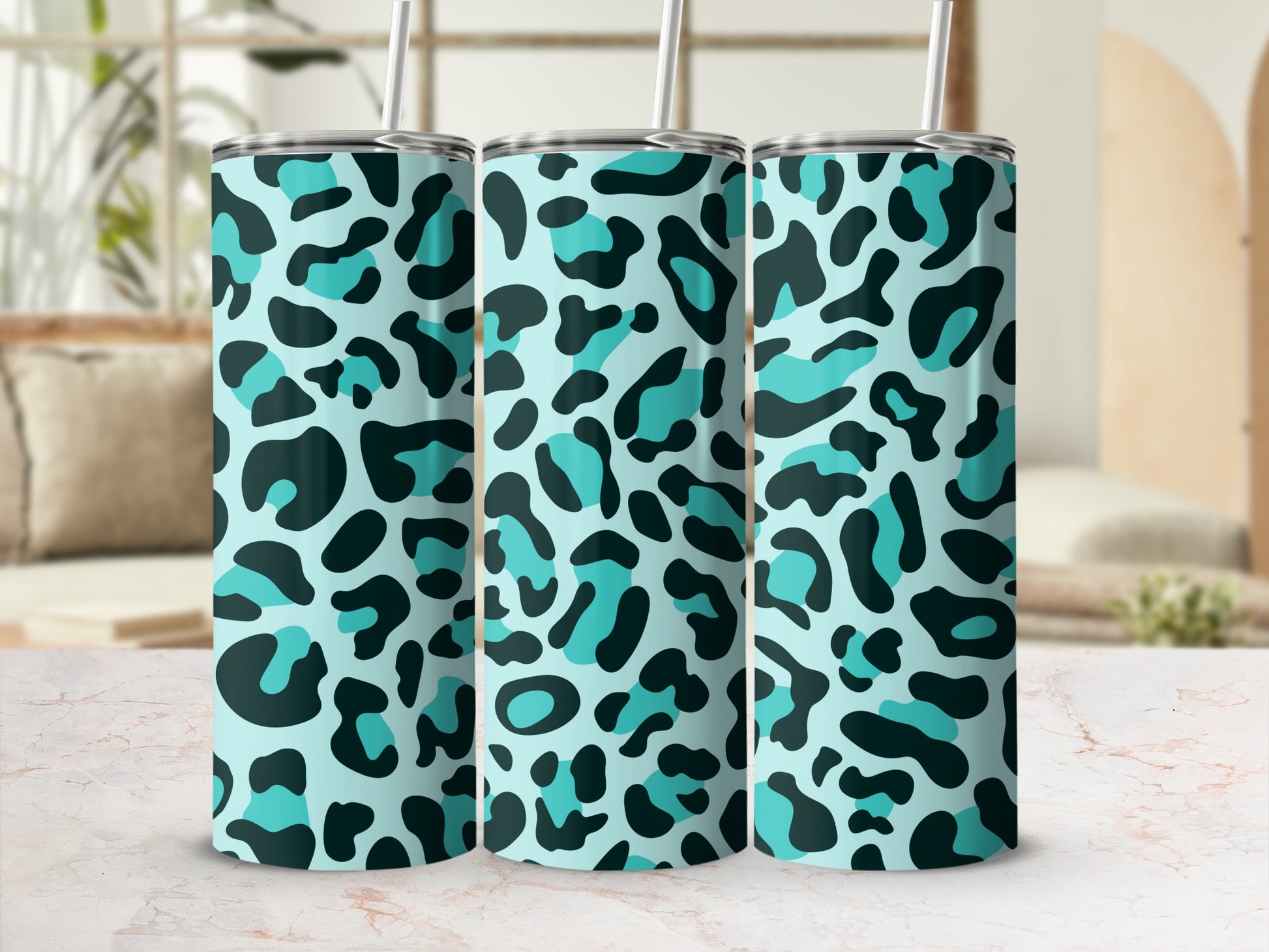 Three tumblers with a light blue background and teal and dark blue leopard print pattern.