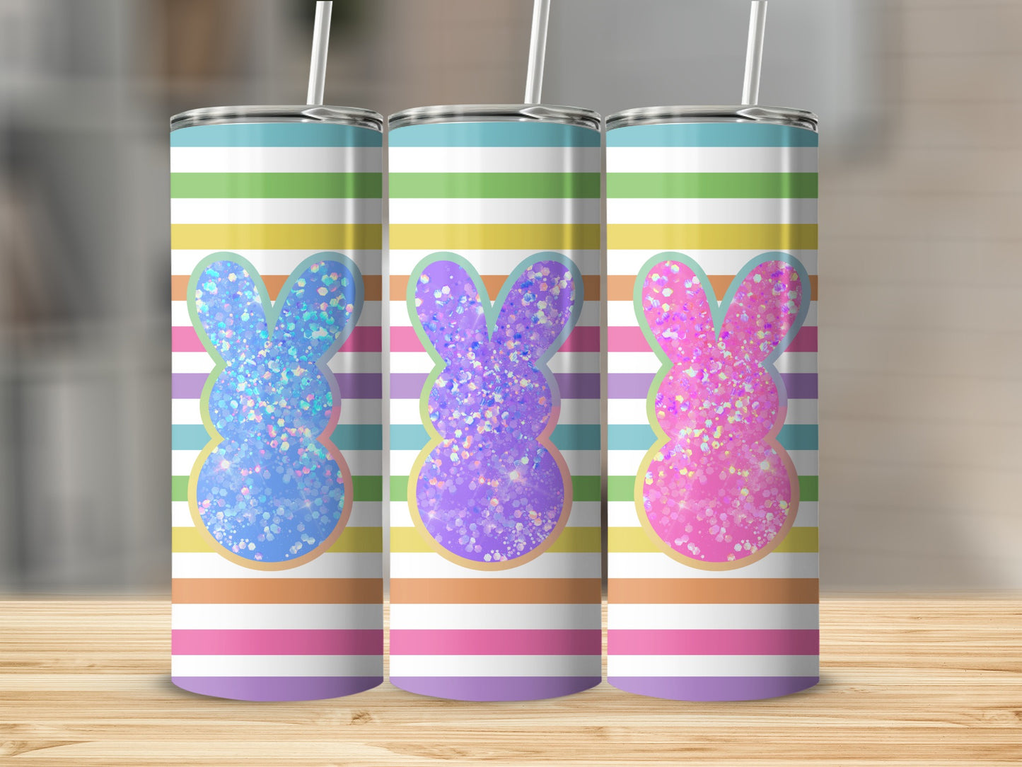 Three glitter bunny tumblers with striped background.