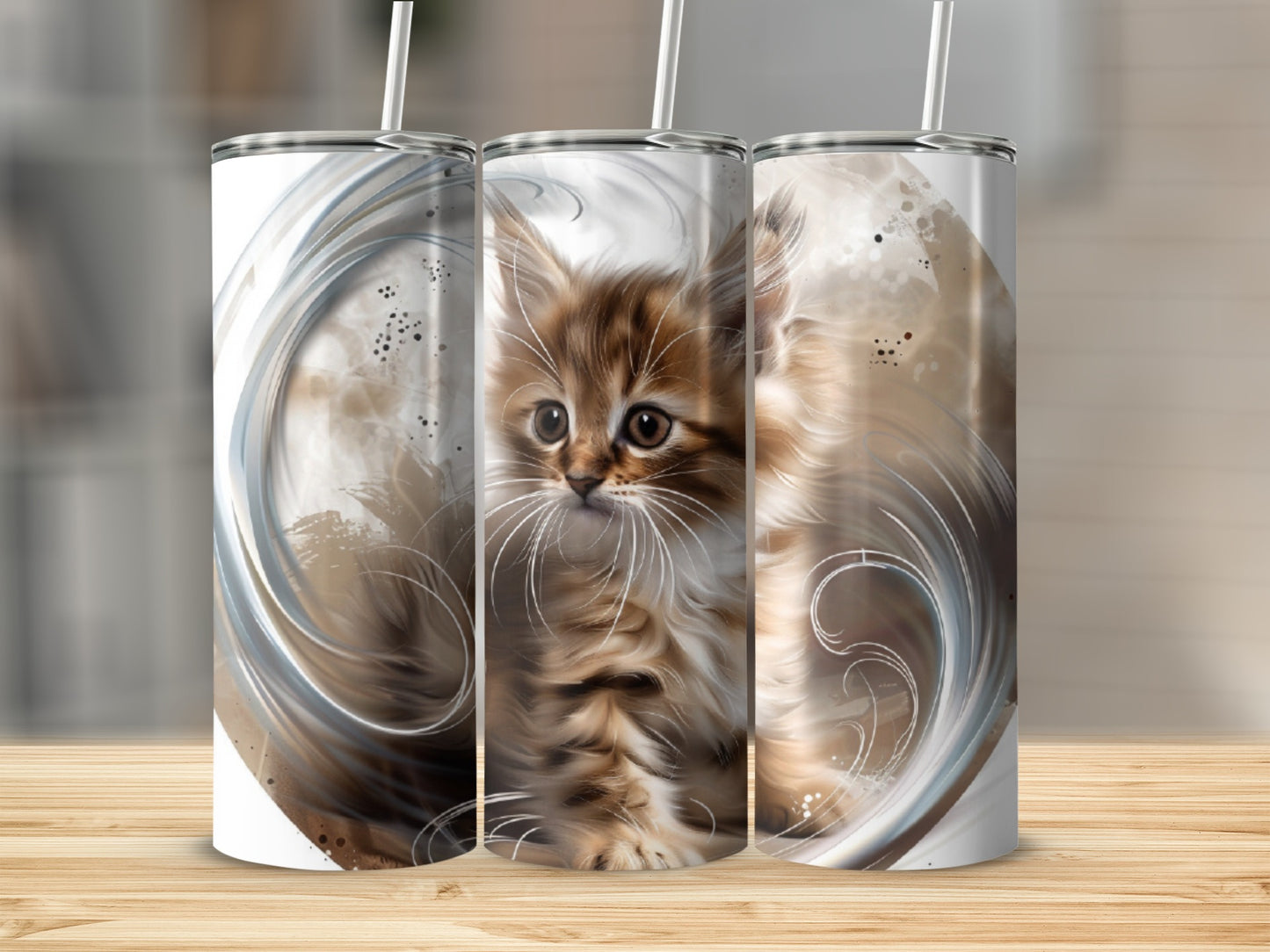 Three tumblers featuring a fluffy tabby kitten with swirling abstract designs.