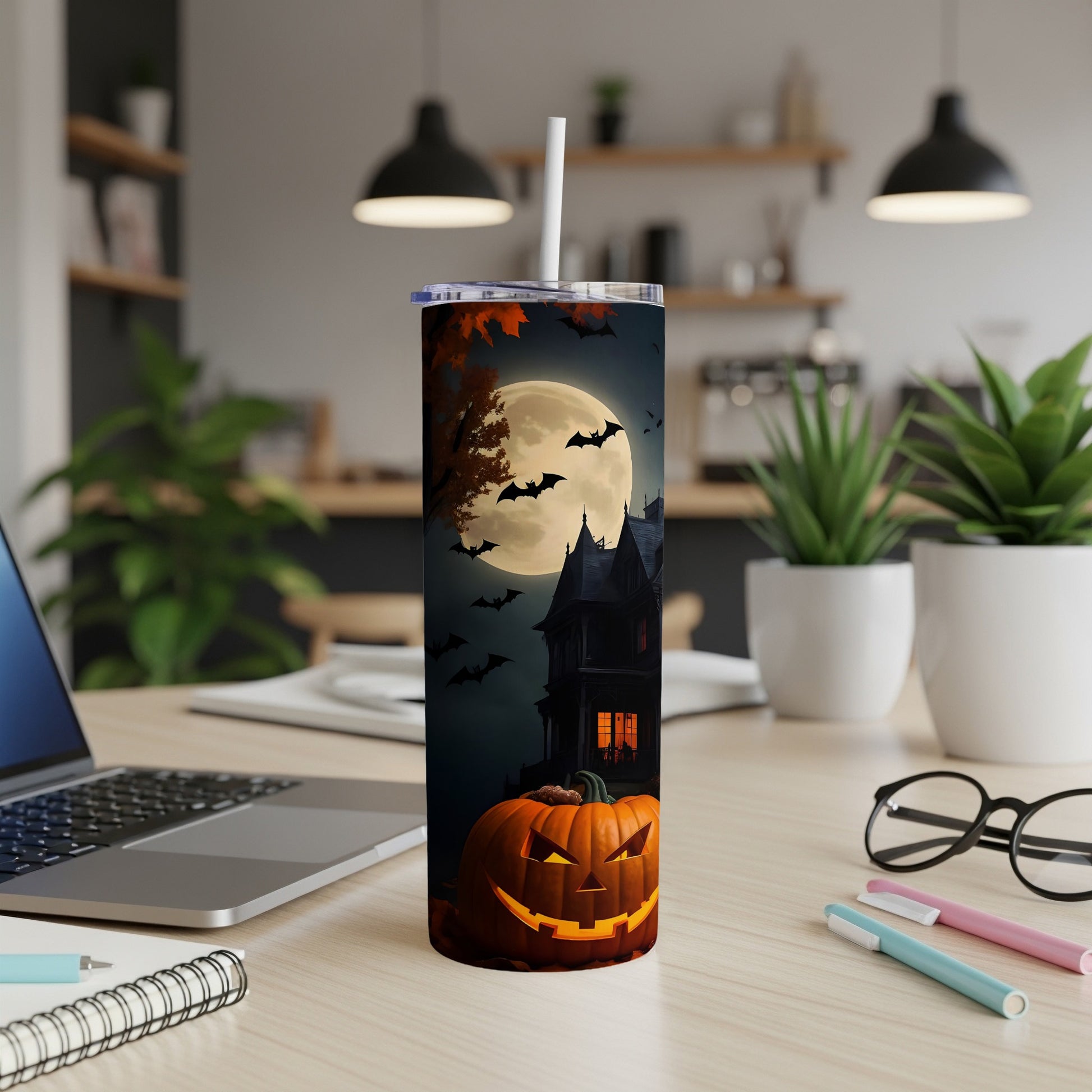Tall tumbler with Halloween design featuring a haunted house, full moon, bats, and a jack-o'-lantern.