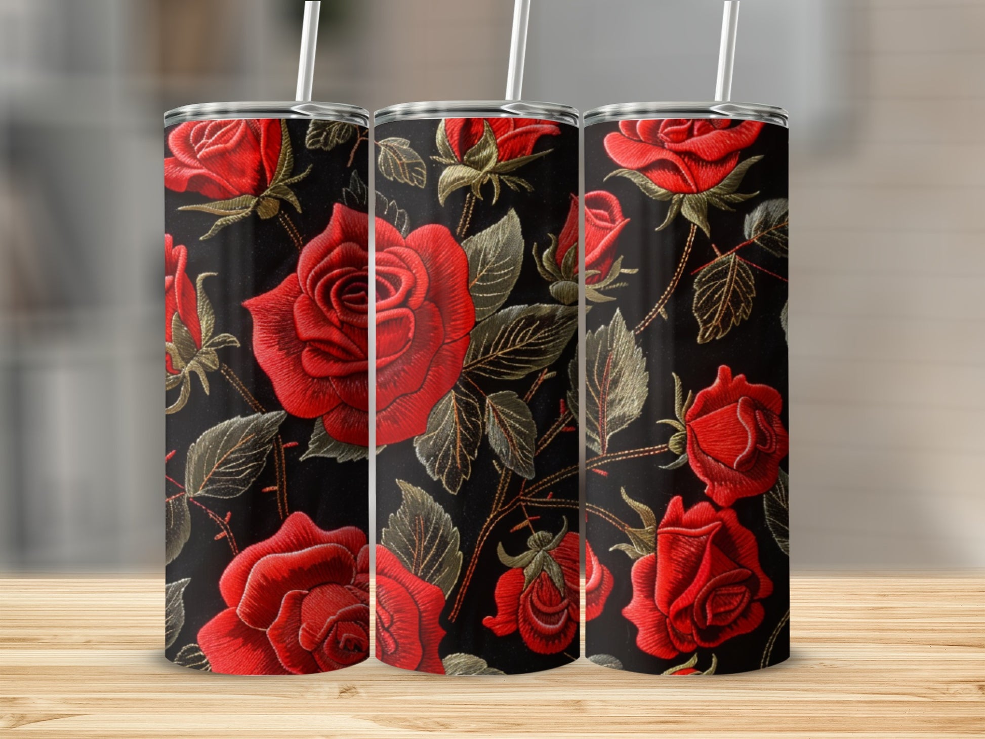 Three tumblers with a red rose floral embroidered design on a black background.
