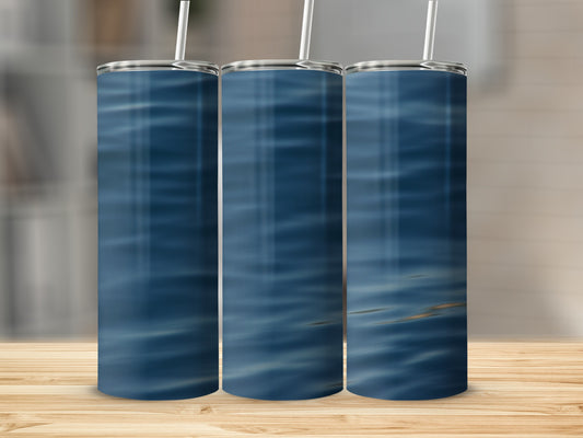 Three tumblers with a blue water ripple pattern stand on a wooden surface.