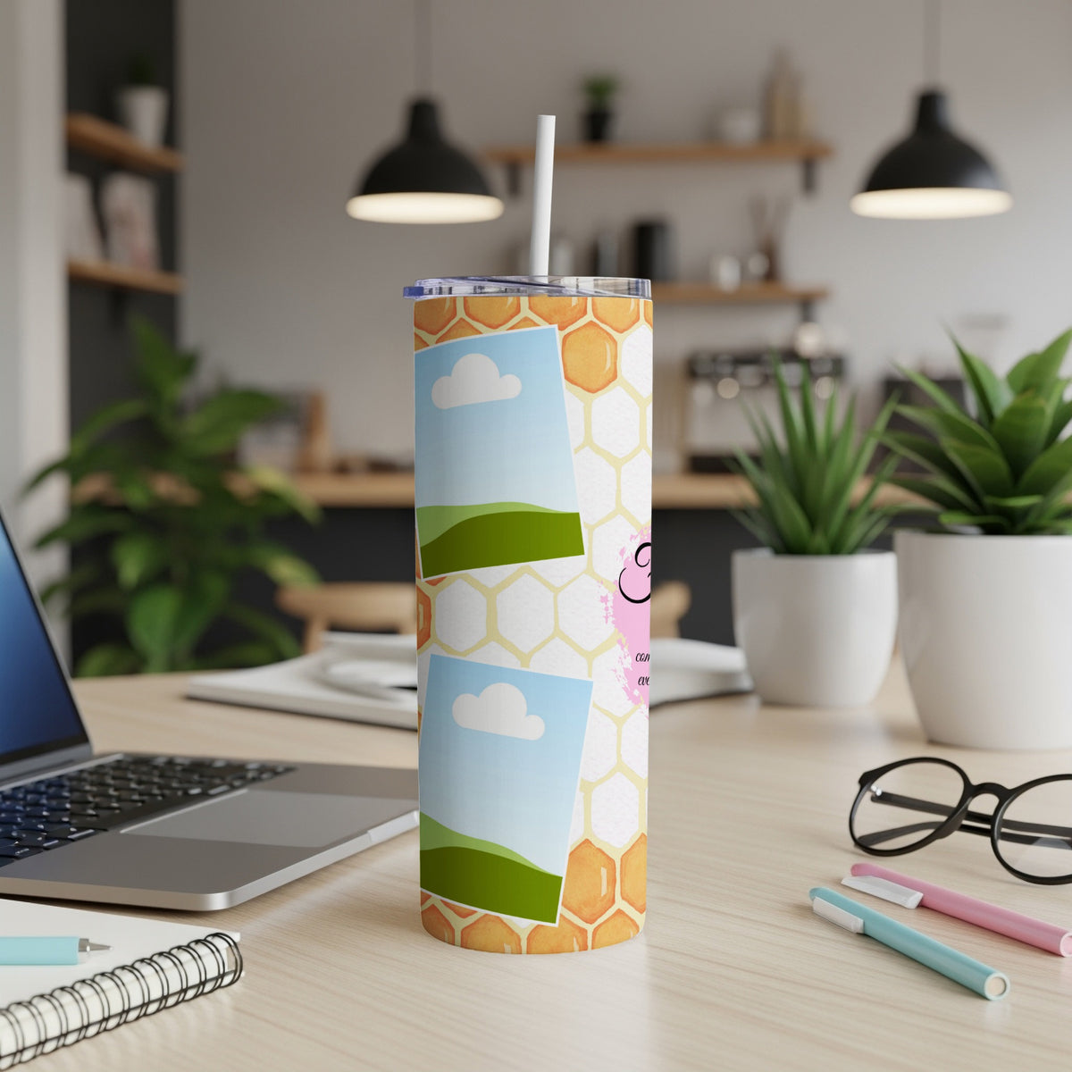 Tumbler with honeycomb pattern and framed photos of clouds and landscapes.