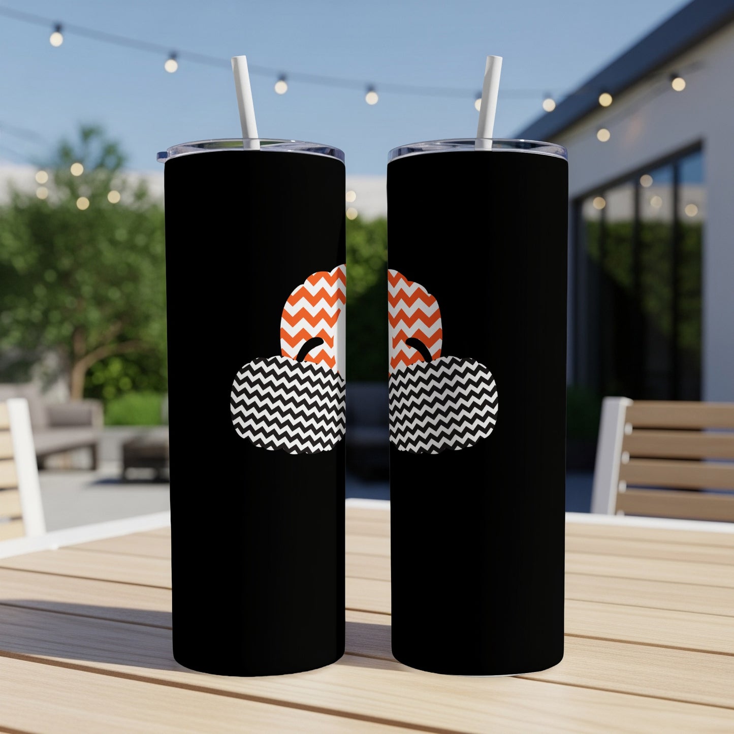 Two black tumblers with orange and white chevron and zigzag patterns.
