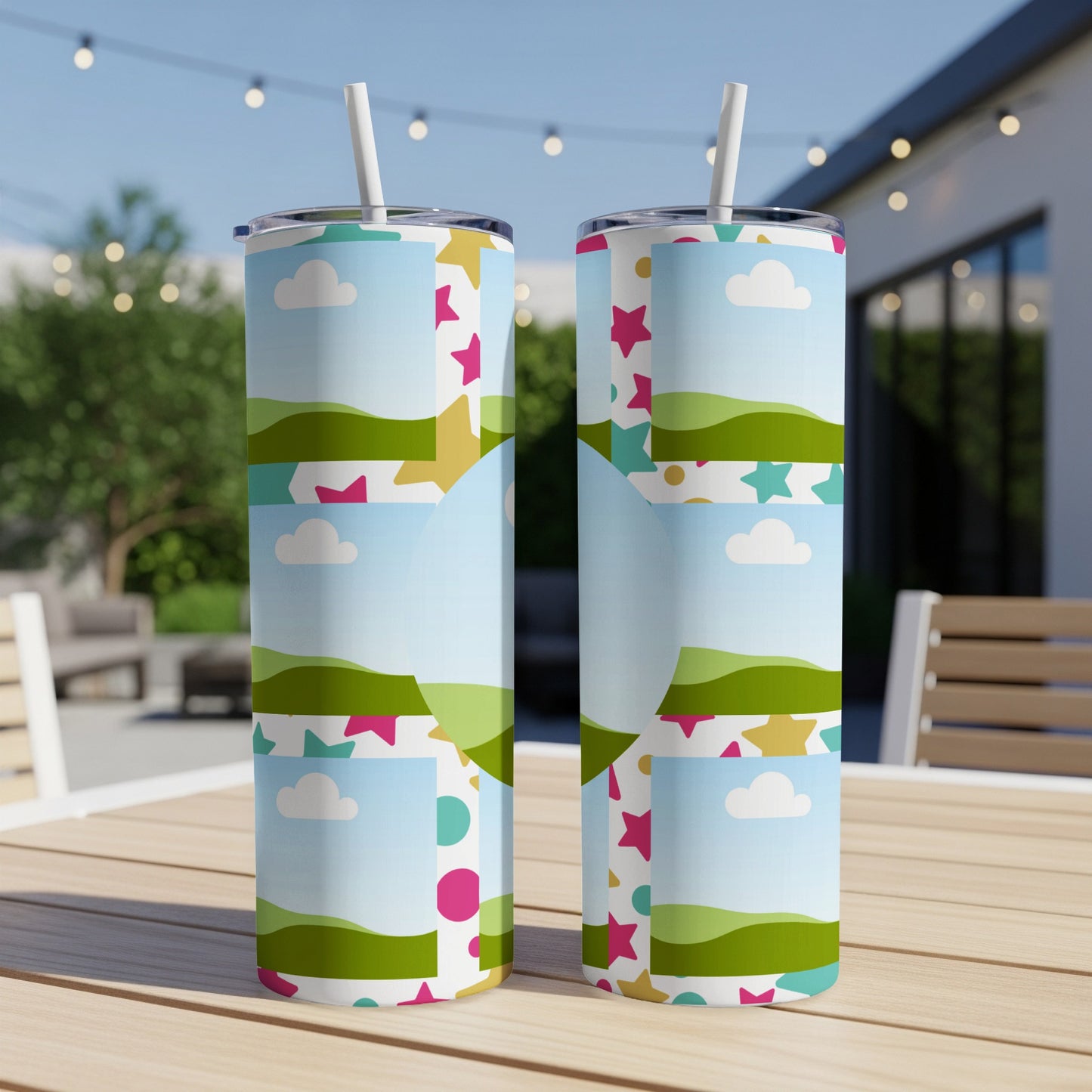 Two tumblers with a colorful landscape and star pattern, each with a straw.
