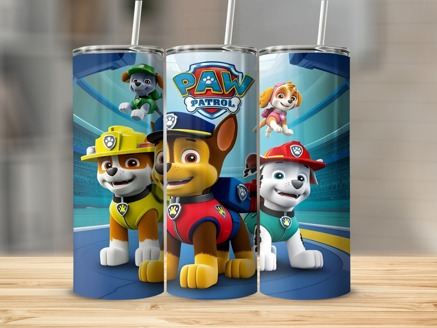 Paw Patrol characters Chase, Marshall, and Skye on a blue tumbler.
