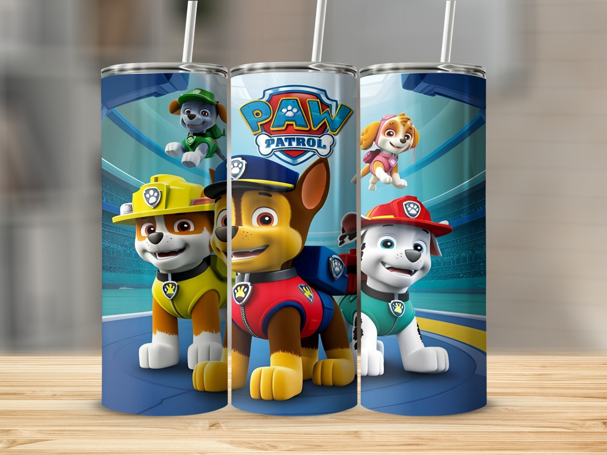 Paw Patrol characters Chase, Marshall, and Skye on a blue tumbler.