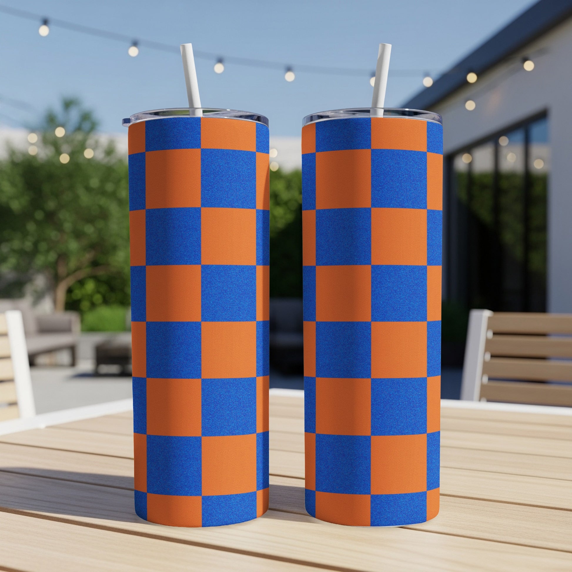 Two tall tumblers with a blue and orange checkered pattern.