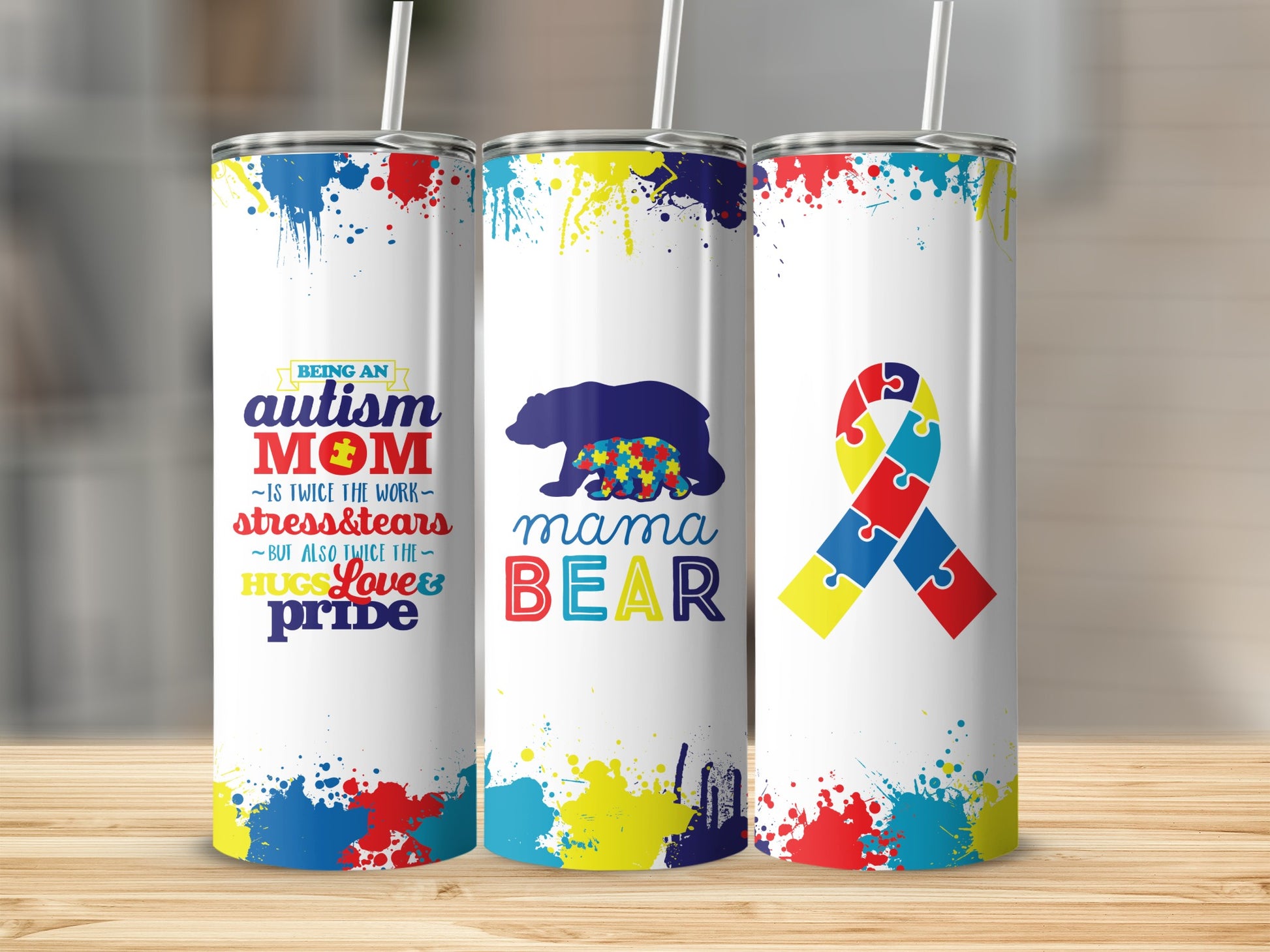 Autism Mom tumbler with colorful paint splatters and bear design.