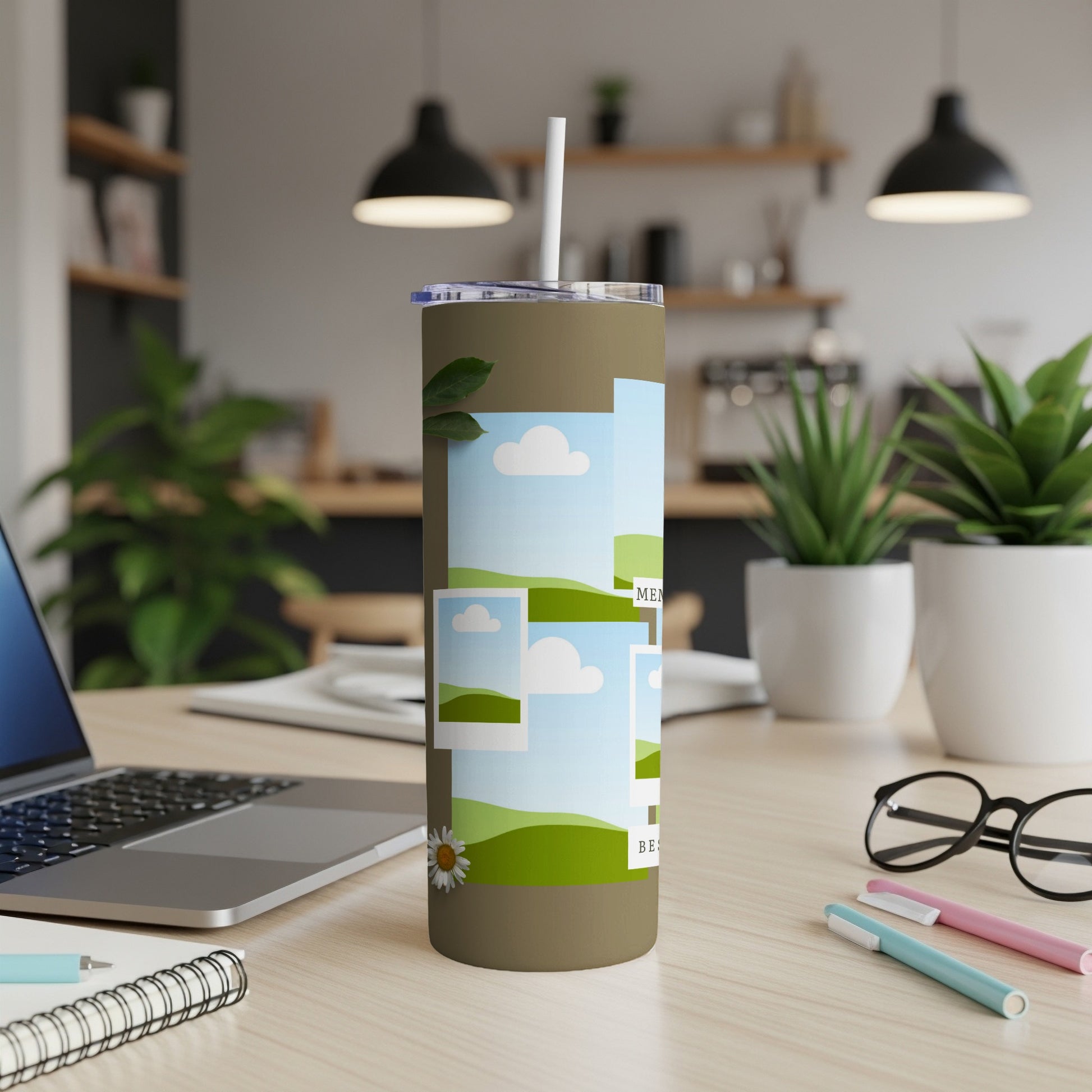 Tan tumbler with scattered photo frames of grassy hills and blue skies.