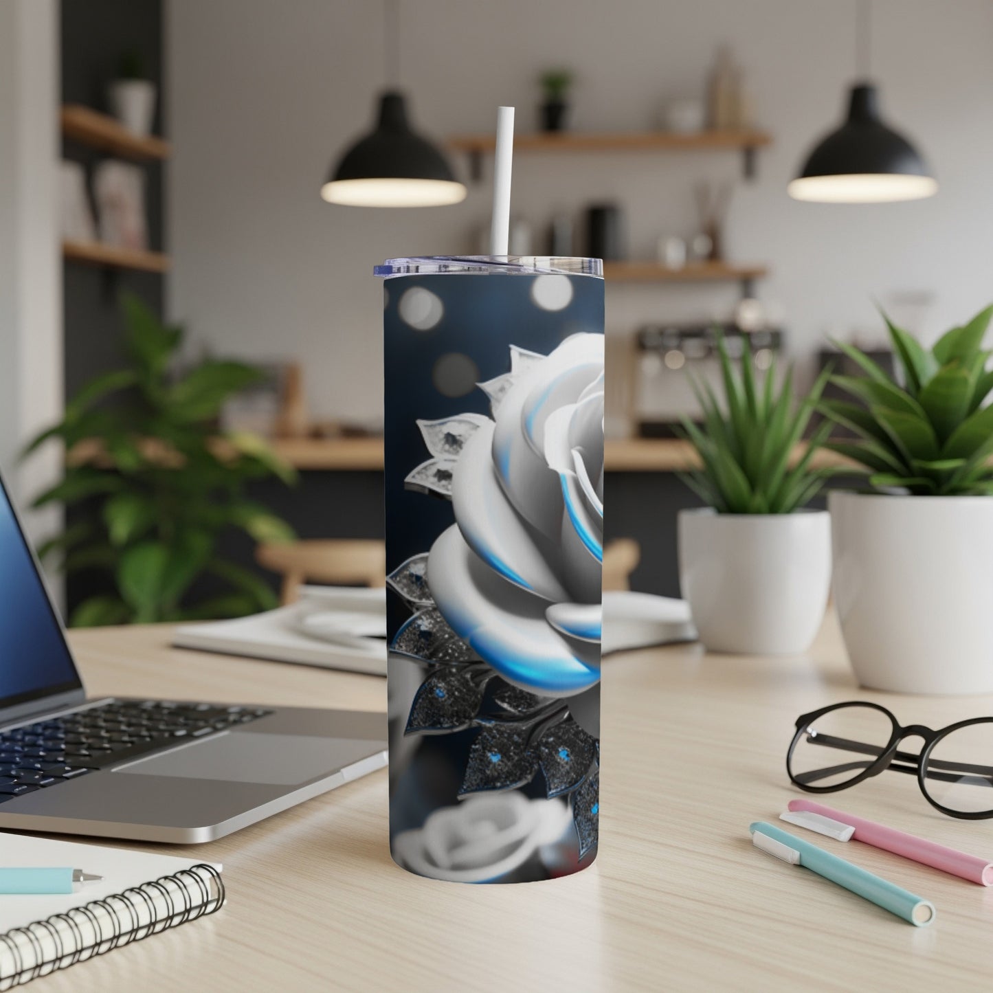 White rose design on a stainless steel tumbler with a straw.