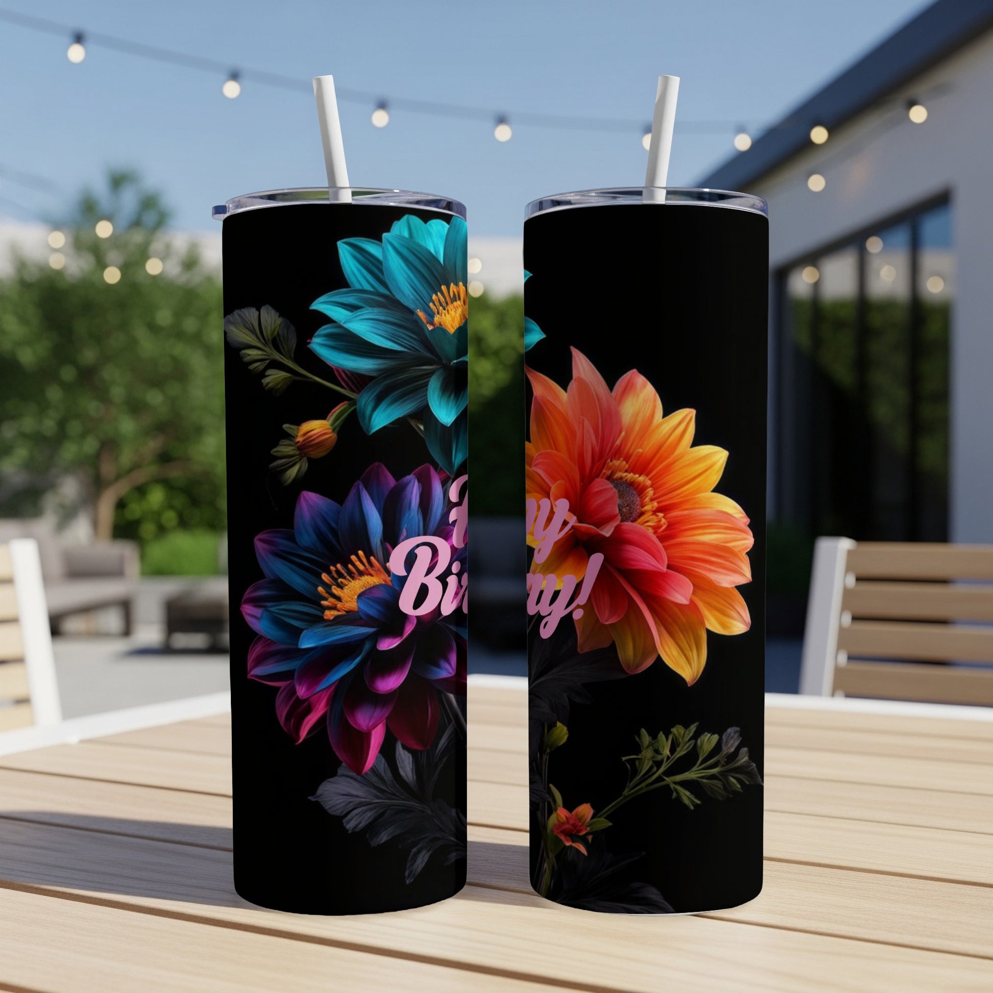 Two tumblers on a table with colorful floral designs and "Happy Birthday!" text.
