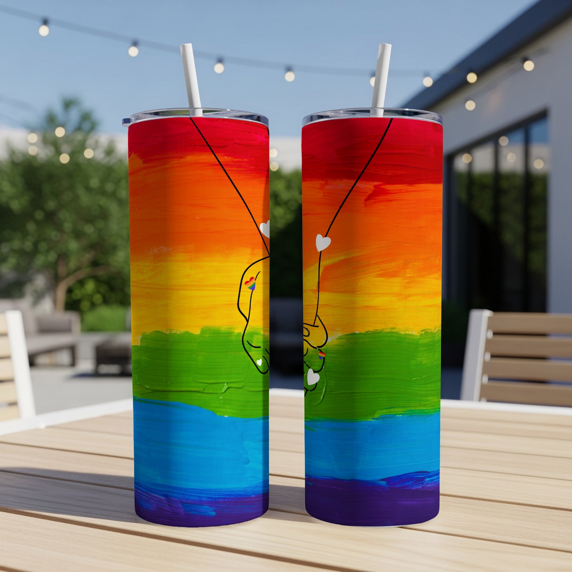 Two tumblers with rainbow stripes and minimalist heart hands design.