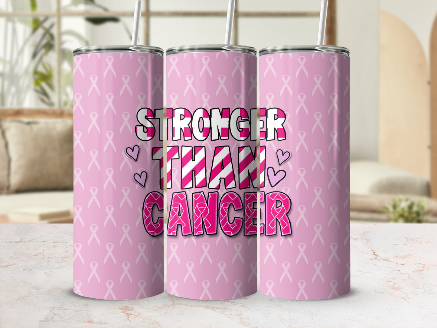 Pink tumbler with "Stronger Than Cancer" text and ribbon pattern.