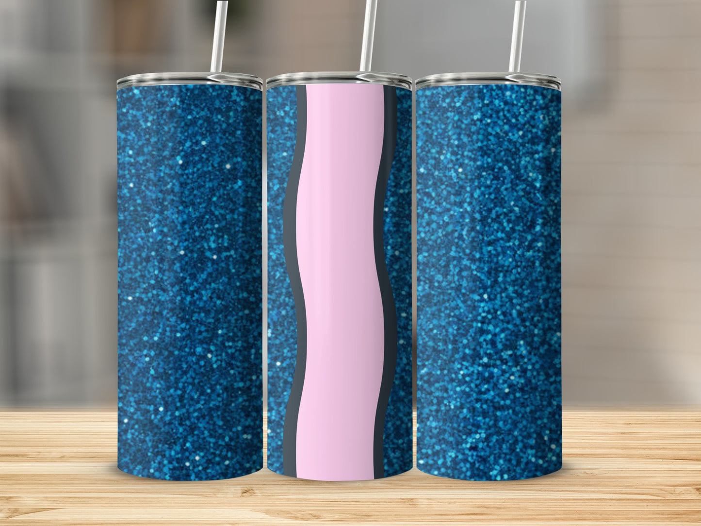 Three glitter tumblers with a pink wavy stripe design on a wooden surface.