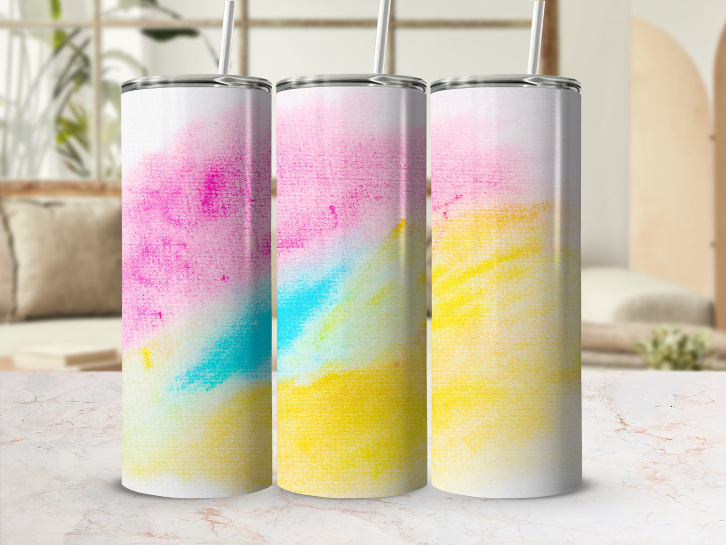 Three tumblers with pink, blue, and yellow watercolor designs.