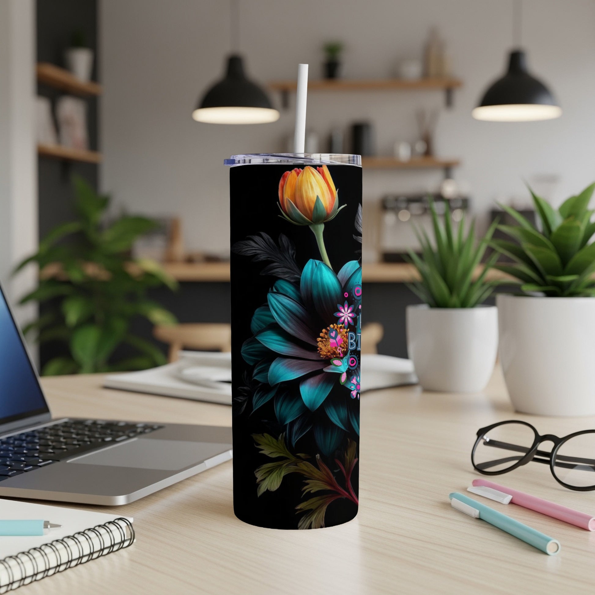 Black tumbler with teal floral design and "Bloom" text.