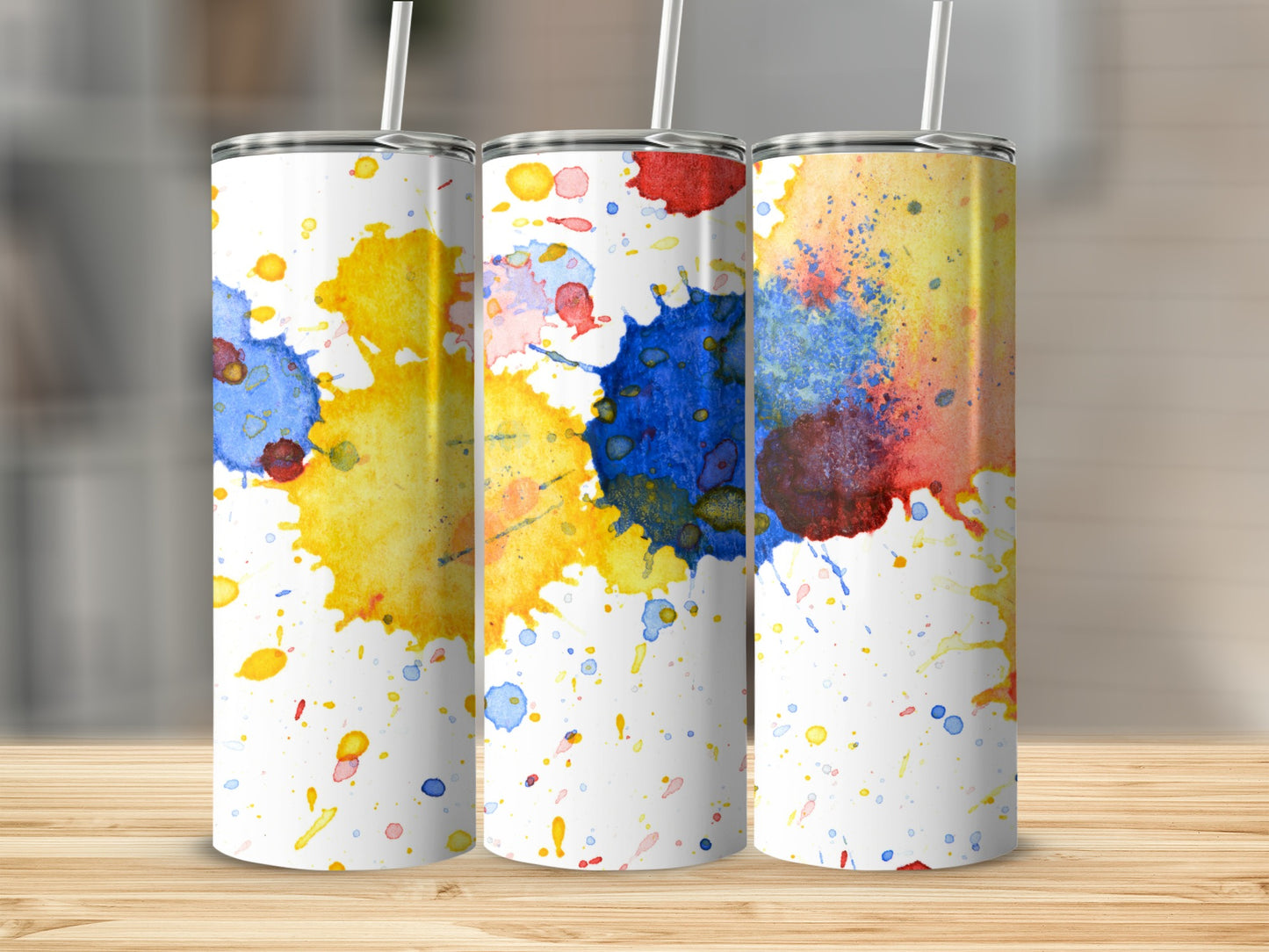 Three tumblers with colorful watercolor splatters.