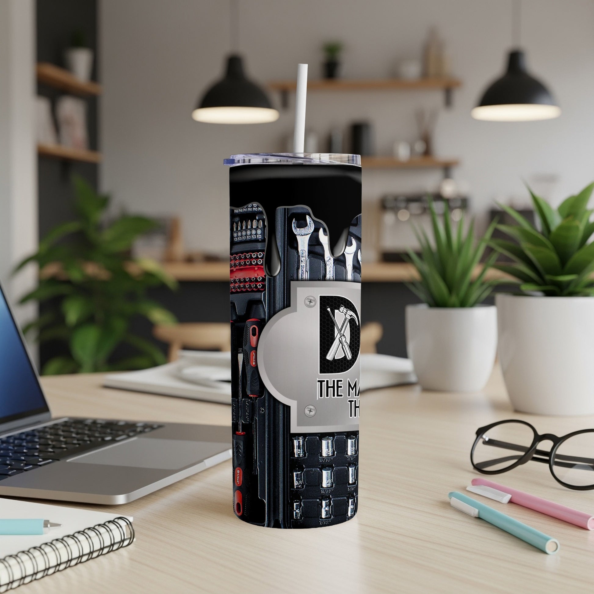 Tumbler with toolbox and wrench graphic. Text reads "THE M TH".