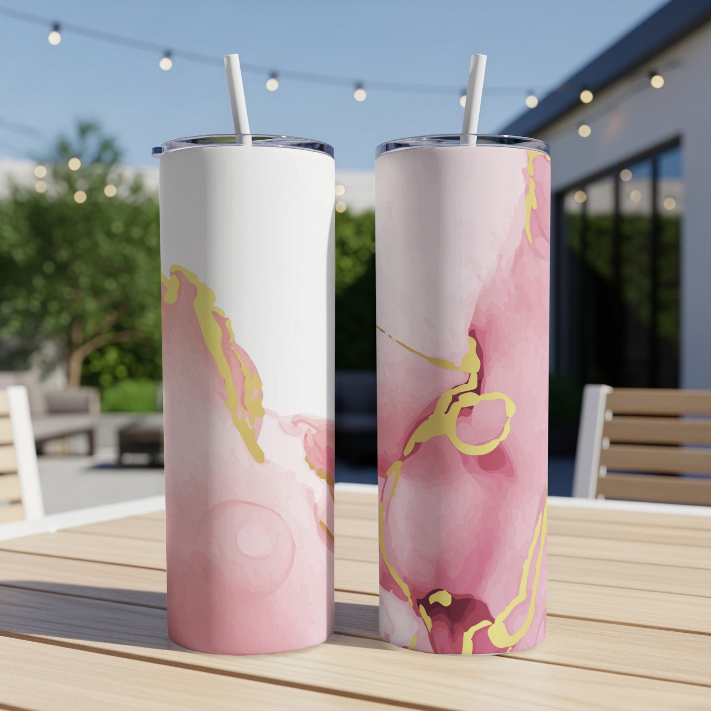 Two tall tumblers with pink and gold abstract watercolor designs.