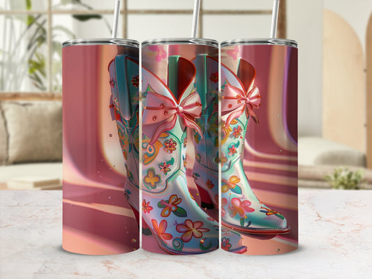 Three teal cowboy boots with floral designs and pink bows, side view.