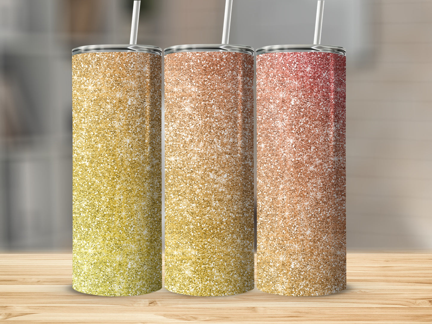 Three glitter tumblers with straws, displaying gradient colors from yellow to red.