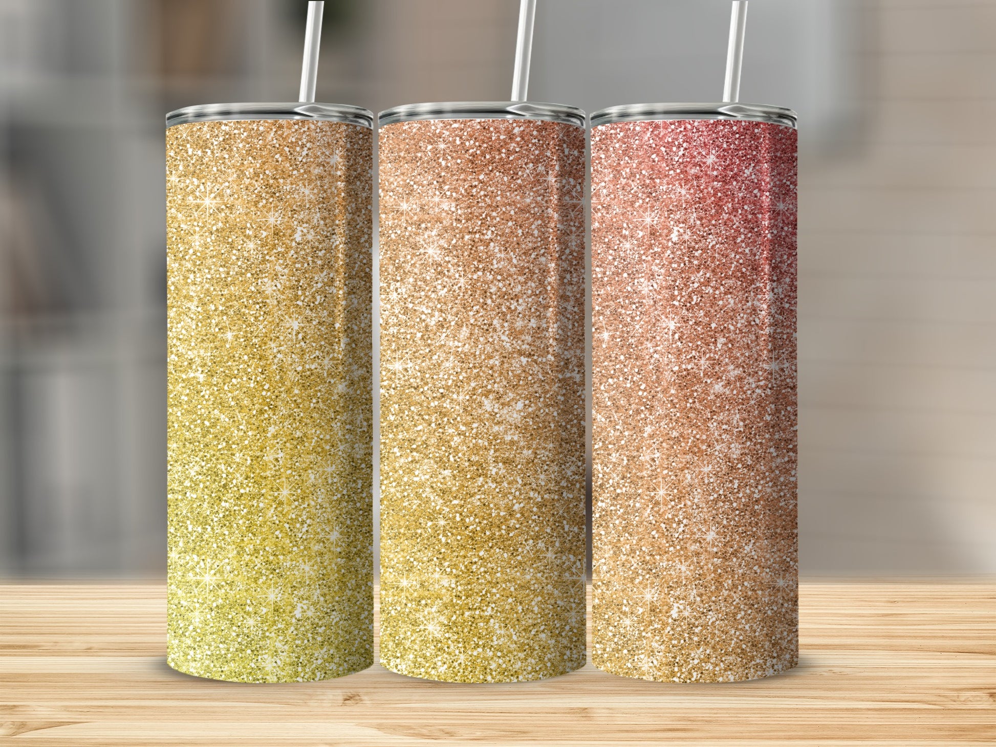 Three glitter tumblers with straws, displaying gradient colors from yellow to red.