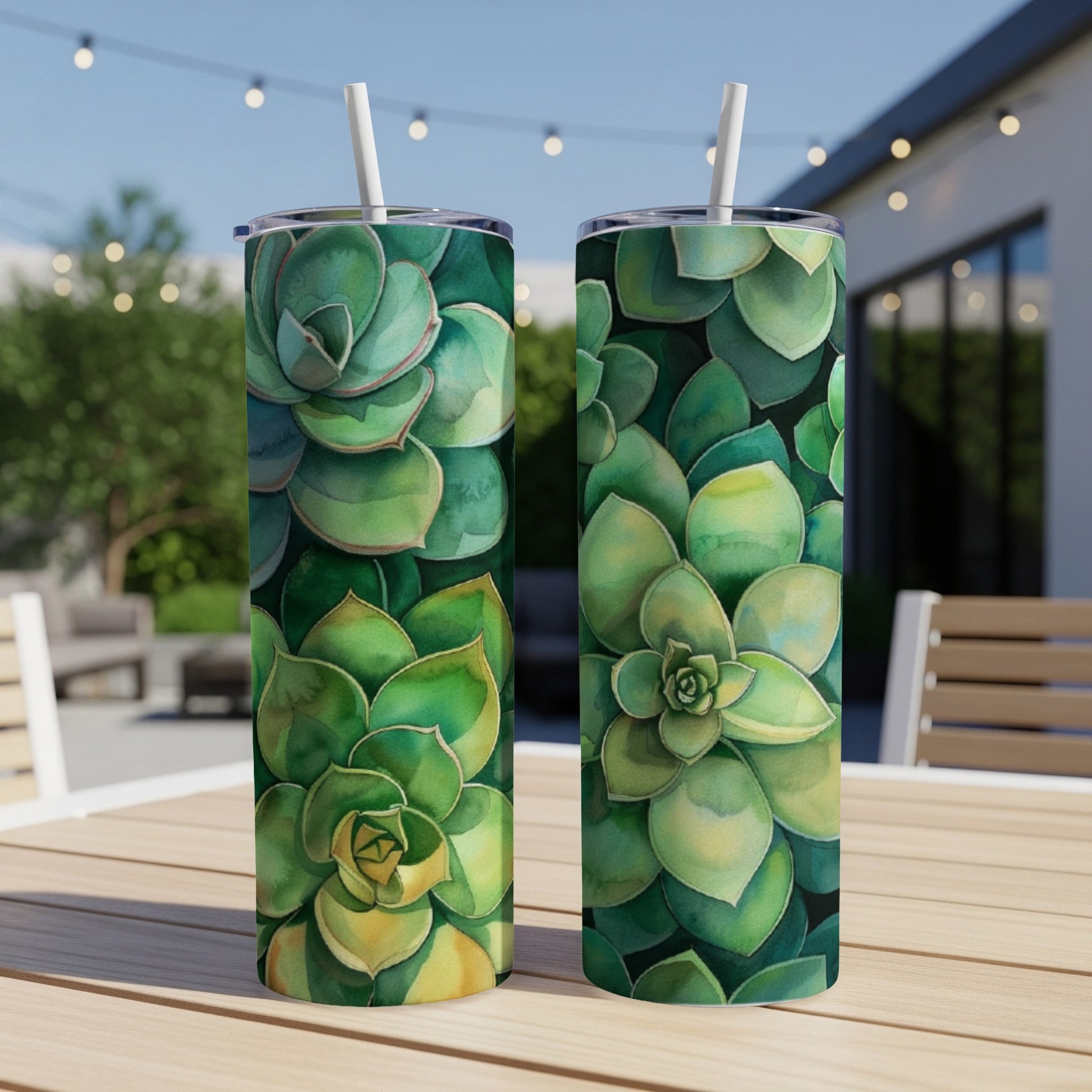 Two tumblers with a succulent plant pattern on a wooden table.