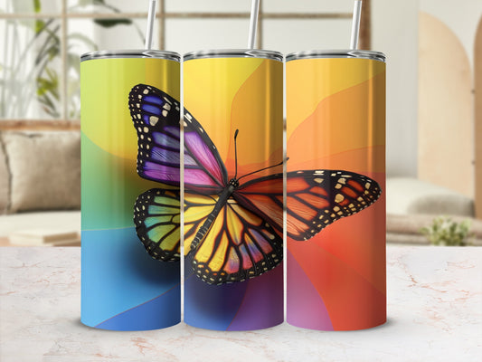 Three tumblers with colorful butterfly designs and rainbow gradients.