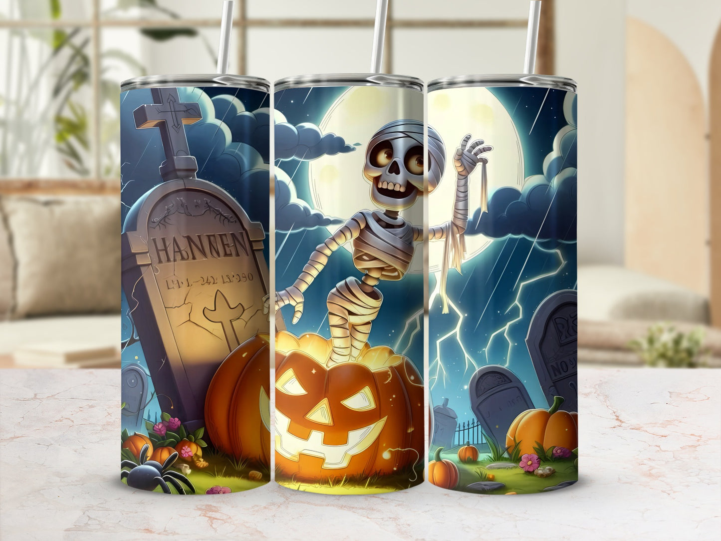 Halloween tumbler with skeleton, tombstone, pumpkins, and spider on a stormy night.