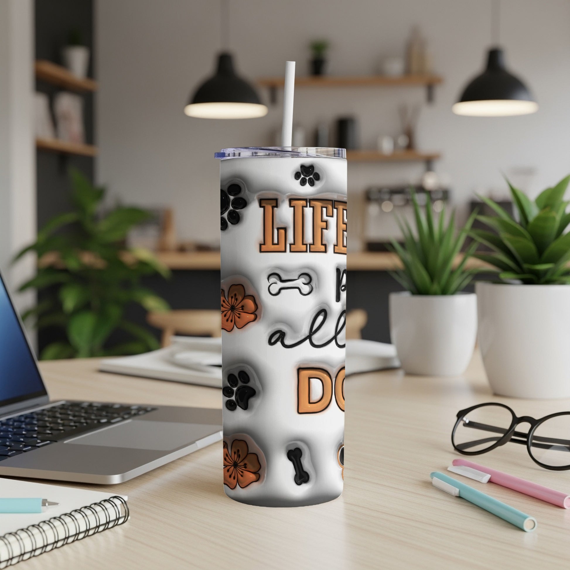 White tumbler with dog paw prints, bone, and flower patterns.