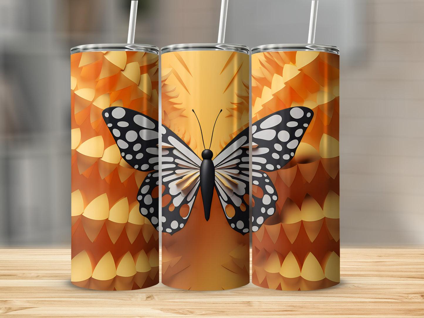 Three tumblers with a black and white butterfly and orange scale pattern.