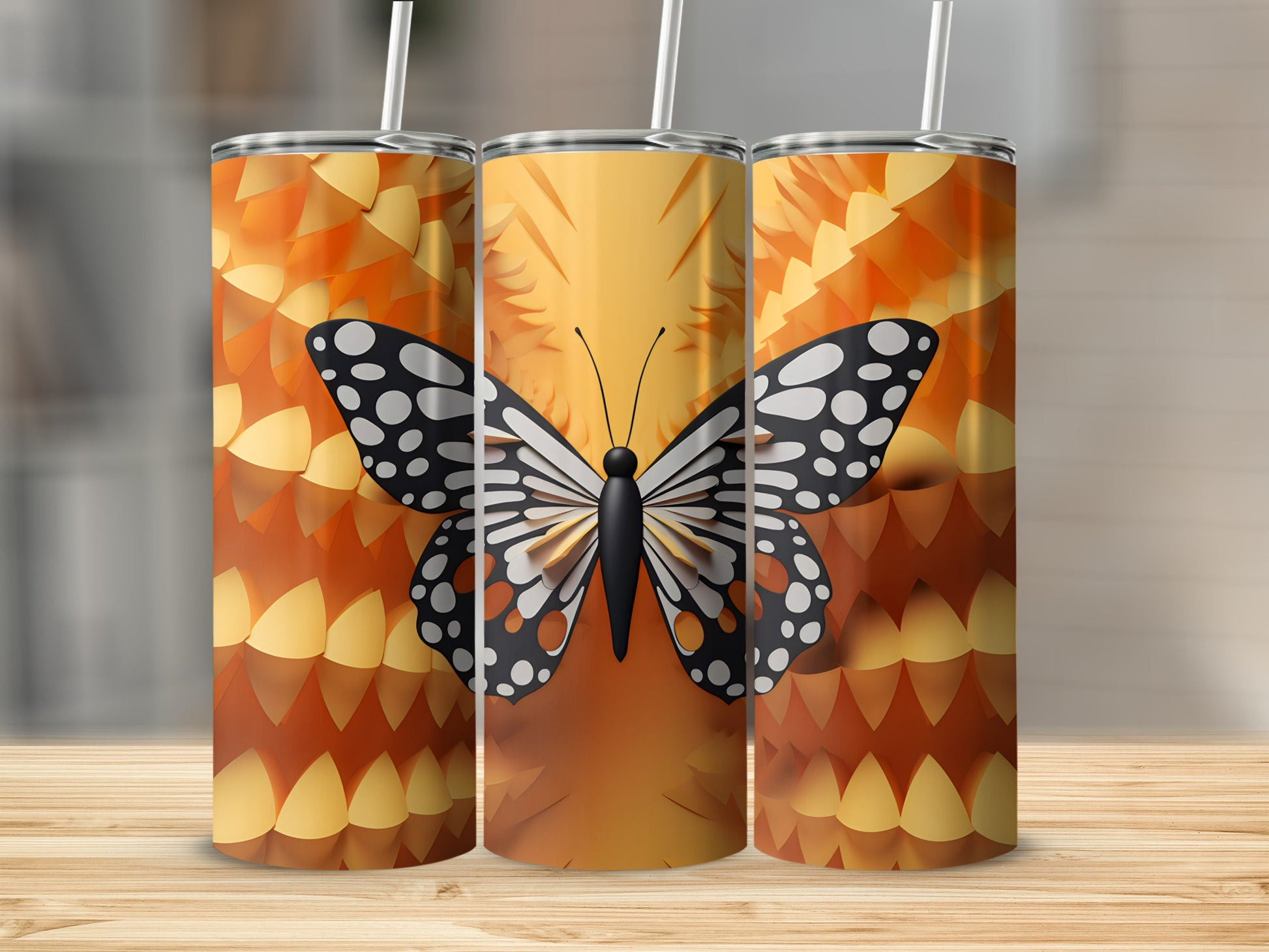 Three tumblers with a black and white butterfly and orange scale pattern.