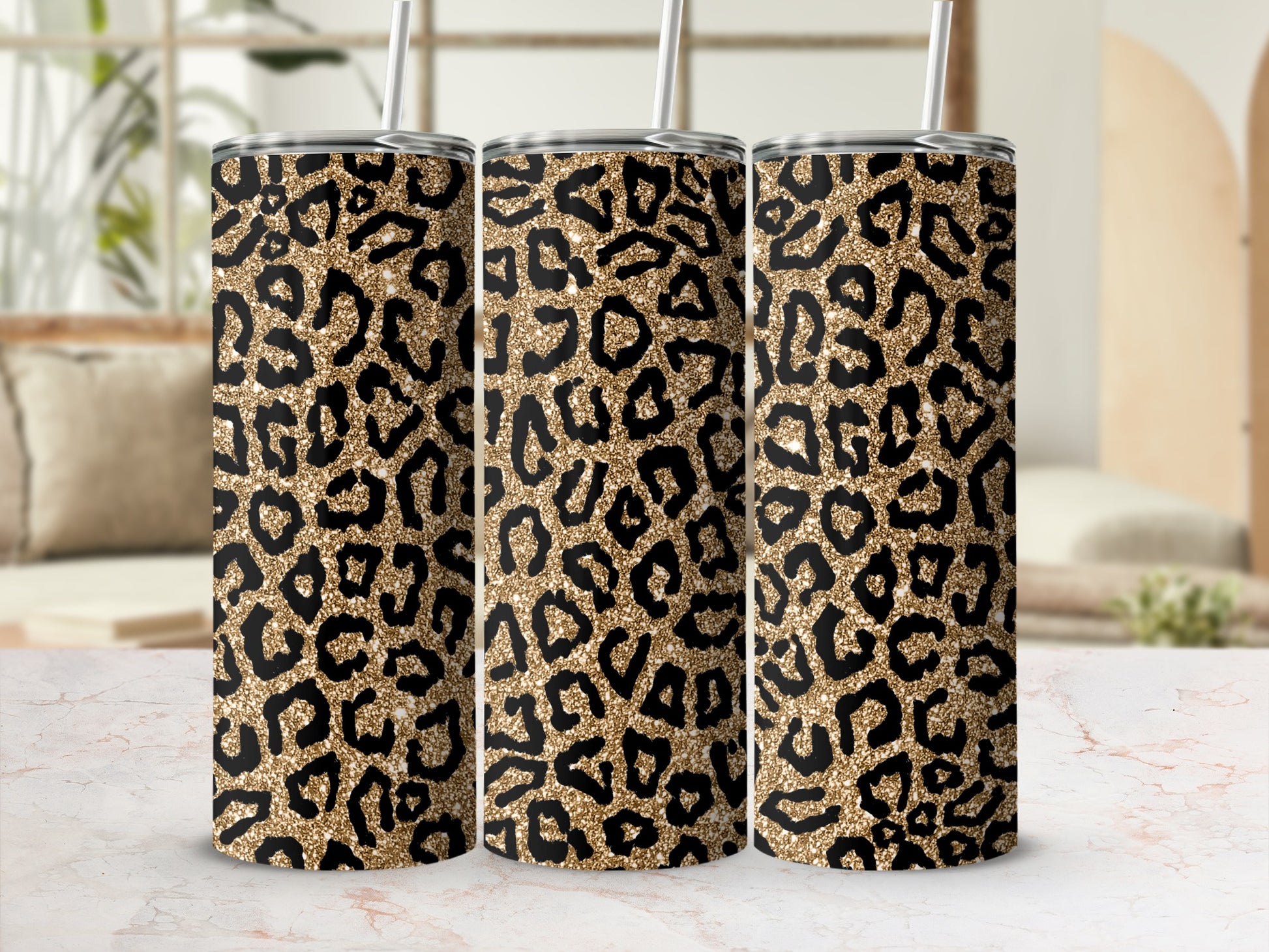 Three tall tumblers with a gold and black leopard print pattern.