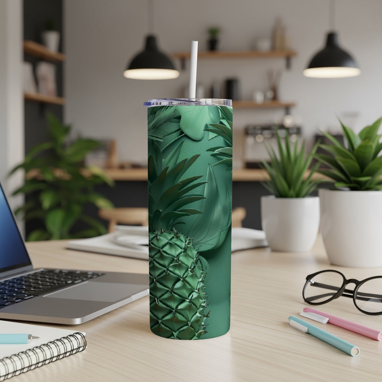 Green pineapple pattern on a stainless steel tumbler with a white straw.