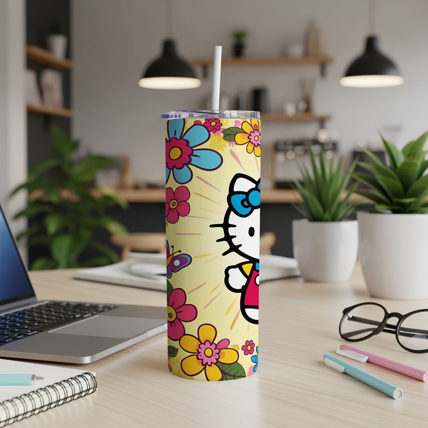 Hello Kitty tumbler with flowers and butterflies on a yellow background.