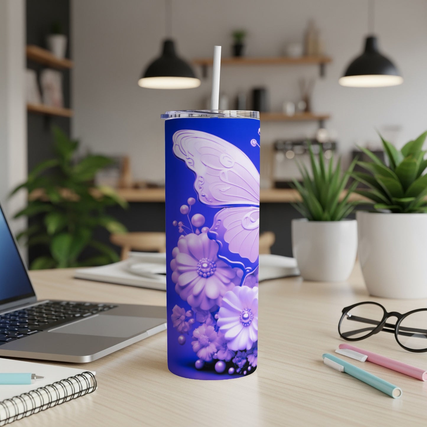 Purple butterfly and floral design on a blue tumbler with a straw.